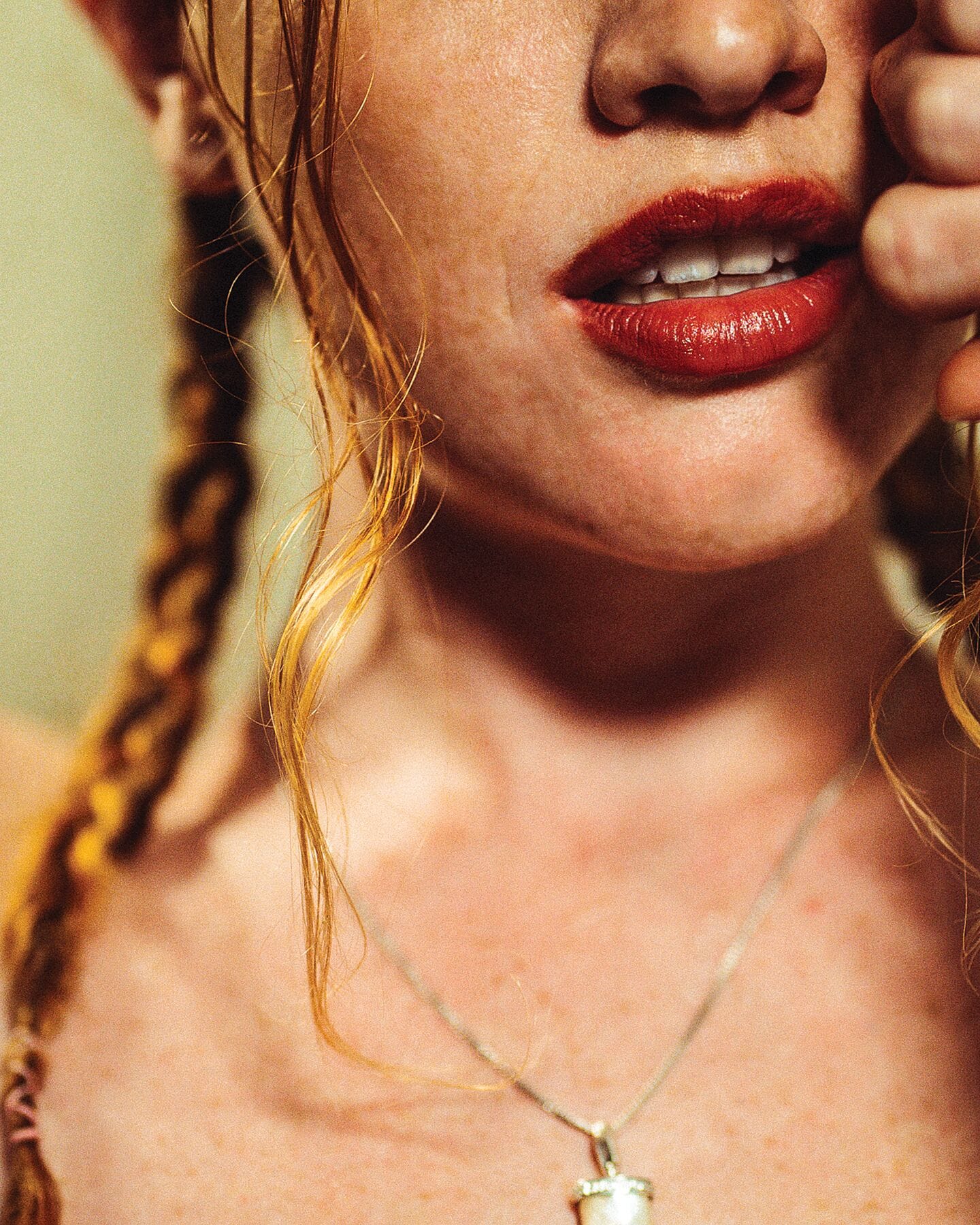Close-up fine art portrait photography of Amy in Tulum, highlighting her bold red lips and necklace, printed on Hahnemühle Photorag.