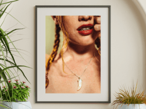 Limited-edition fine art print of Amy in Tulum, focusing on bold red lips and a striking necklace, crafted on Hahnemühle Photorag.