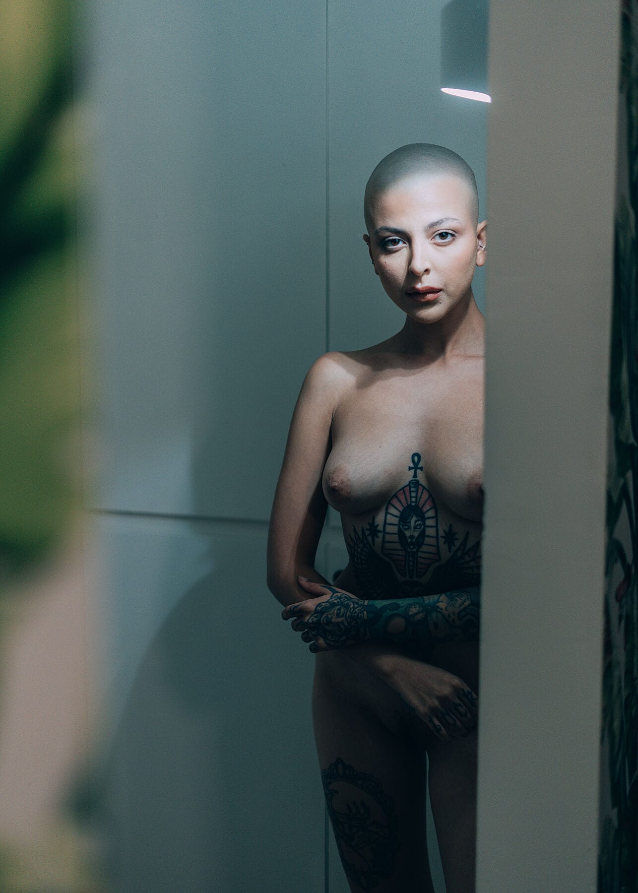 Expressive fine art nude portrait of Madam Sophie in soft lighting, showcasing her tattoos and artistic elegance, printed on Hahnemühle Bamboo paper.
