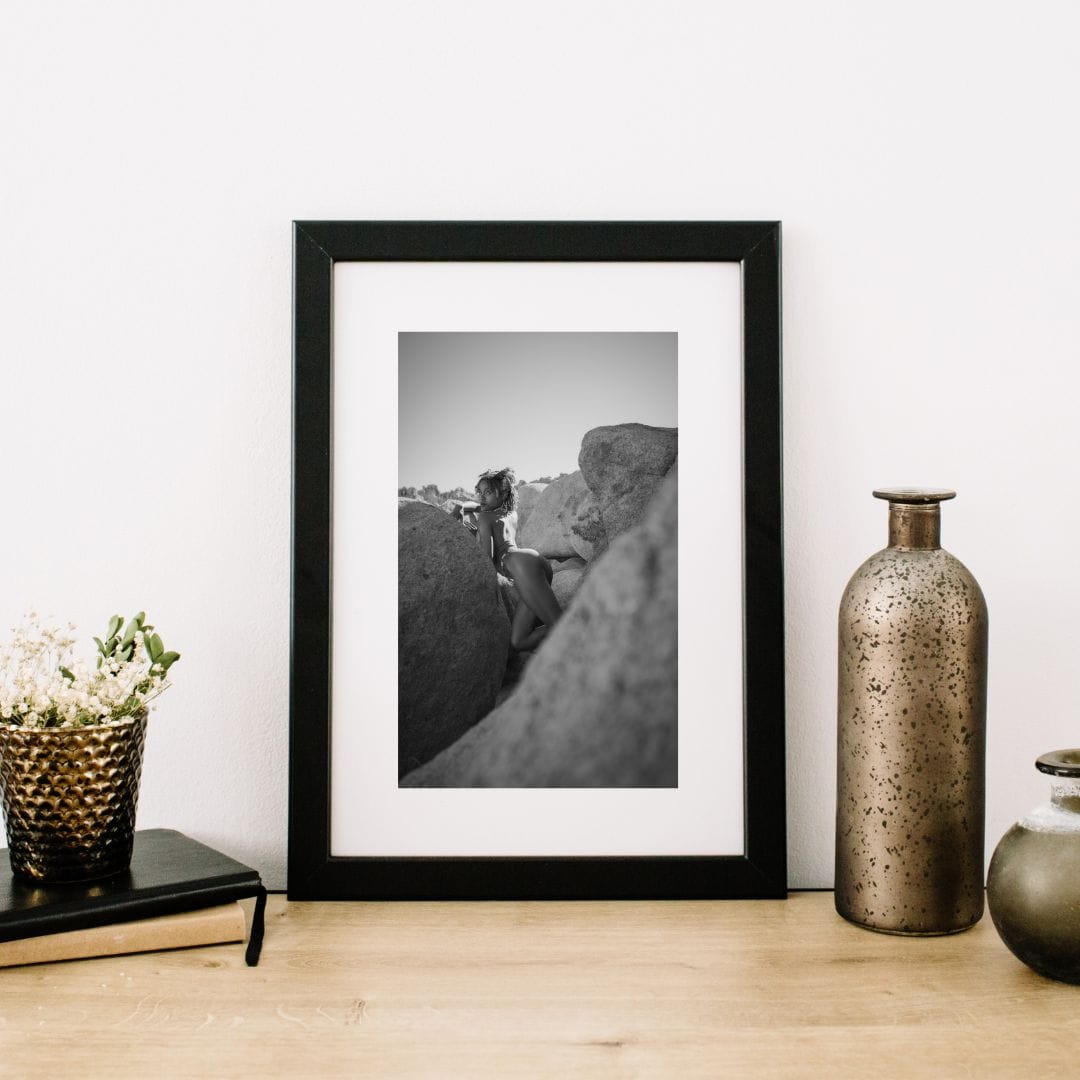 Framed Silent Monument desert fine art nude photography print featuring Divine displayed in a minimalist living room